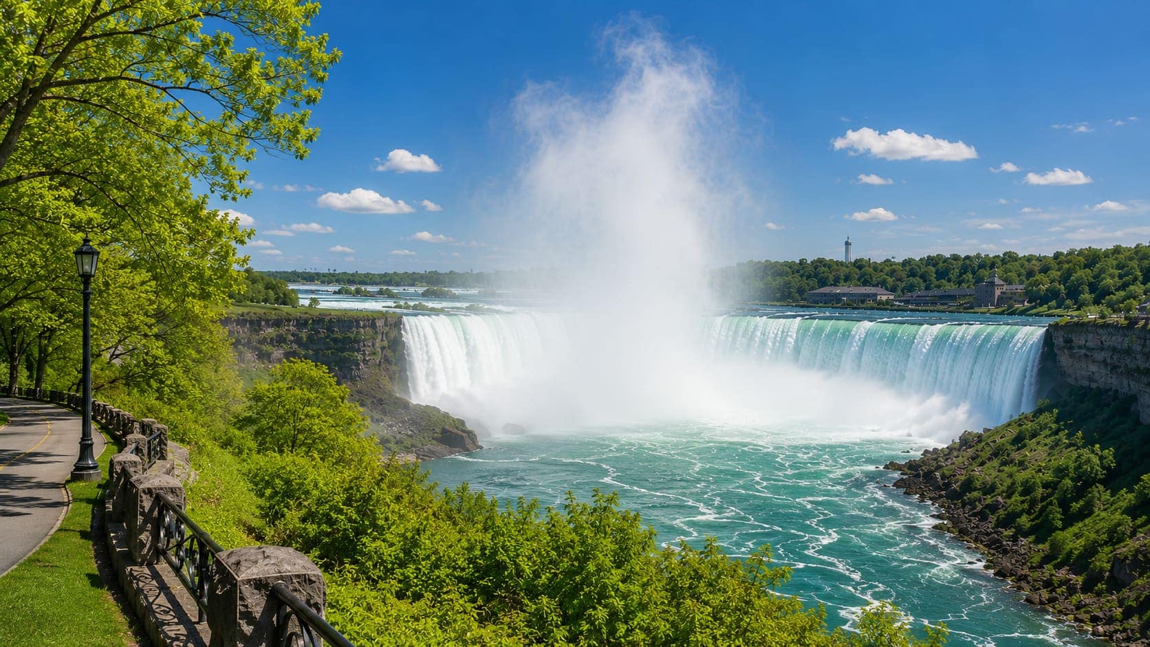 Horseshoe Falls viewed from the Niagara Parkway in spring with trees in full leaf and high water volume visible
